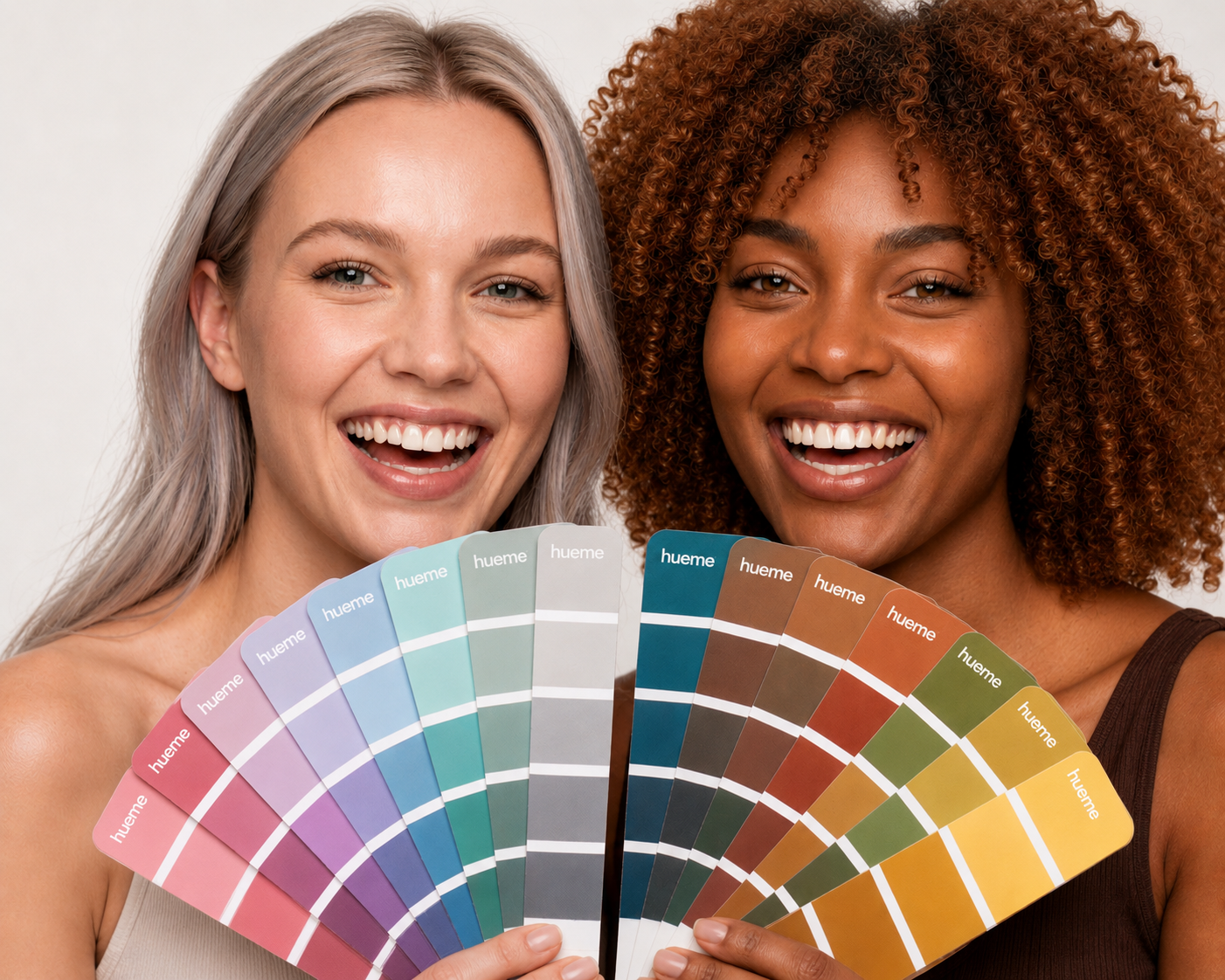 Two smiling women holding hueme seasonal colour fans